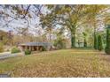 Expansive backyard featuring mature trees and lush greenery, offering privacy and space for outdoor activities at 7111 Indian Creek Sw Cir, Covington, GA 30014