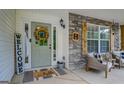 Close-up of the welcoming front door with wreath and decorative accents at 160 Laurel Ln, Social Circle, GA 30025
