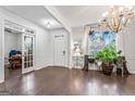 Bright living room with hardwood floors, view into office, chandelier lighting, decorative trim at 412 Culloden Moor, Mcdongough, GA 30253