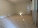 Neutral bedroom with soft carpet, white trim, natural light, and closet at 984 Morrow Rd, Morrow, GA 30260