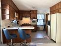 Vintage-style kitchen featuring wood cabinetry, breakfast bar, and a view to backyard at 984 Morrow Rd, Morrow, GA 30260