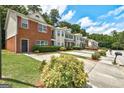 View of the townhouses with landscaped yards and private parking areas at 4862 Park Cir, Atlanta, GA 30349