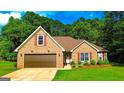 Traditional brick home with a well-maintained lawn, an attached two-car garage, and inviting curb appeal at 6830 Peeksville Rd, Mcdonough, GA 30252
