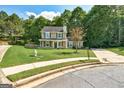 Charming two-story home featuring a well-manicured lawn and classic green shutters at 1600 Coal Shovel Ne Trl, Conyers, GA 30013