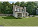 Charming two-story home featuring a well-manicured lawn and classic green shutters at 1600 Coal Shovel Ne Trl, Conyers, GA 30013
