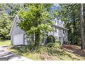 View of house with white garage door, manicured bushes and a circular driveway at 345 Kerrith Dr, Stockbridge, GA 30281