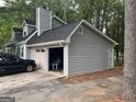 View of the home's exterior, showing the siding, roof, and garage at 4514 Tifton Ct, Powder Springs, GA 30127