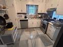 Functional kitchen with cabinets, appliances, and a window at 4514 Tifton Ct, Powder Springs, GA 30127
