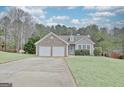 Attractive single-Gathering home with stone detail, vinyl siding, an attached two-car garage and groomed lawn at 131 Meadowbrook Ln, Grantville, GA 30220