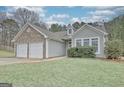 Desirable home featuring a two-car garage, stone elements, vinyl siding and an attractive lawn at 131 Meadowbrook Ln, Grantville, GA 30220
