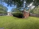 The property shows a well-maintained lawn, some foundation plantings, and partial brick facade at 3885 Morning Creek Dr, South Fulton, GA 30349