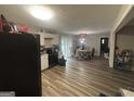 Efficient kitchen layout with black appliances, white cabinetry, and dining area with natural light at 3885 Morning Creek Dr, South Fulton, GA 30349