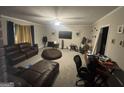 Cozy living room with neutral walls, plush seating, and a ceiling fan at 3885 Morning Creek Dr, South Fulton, GA 30349