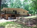 Spacious backyard features a balcony, brick elements, and a well-kept lawn at 205 Avon Dr, Fayetteville, GA 30215