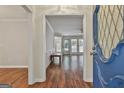 Inviting foyer with hardwood floors flowing into a spacious living area with ample natural light from windows at 107 Jennings Yard, Peachtree City, GA 30269