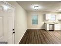 Dining area with stainless steel appliances, view of kitchen and hardwood floors at 604 Thomasville Blvd, Atlanta, GA 30315