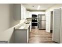 Modern kitchen with stainless steel appliances, granite countertops and white cabinets at 604 Thomasville Blvd, Atlanta, GA 30315
