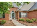 Inviting front entrance with brick facade, a pathway and well maintained landscaping at 1917 Kevin Se Dr, Conyers, GA 30013