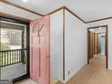 Welcoming foyer featuring tile floors, a pink front door and view to the porch at 1001 Stagecoach Rd, Stockbridge, GA 30281