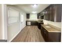 Updated kitchen featuring granite countertops, stainless steel appliances, and dark wood cabinets at 2469 Baywood Se Dr, Atlanta, GA 30315