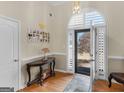 Inviting foyer featuring hardwood floors, elegant decor, and an abundance of natural light at 200 Magnolia Ct, Mcdonough, GA 30252
