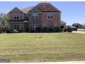 Charming two-story brick home with manicured lawn and established shrubbery at 160 Elysian Dr, Fayetteville, GA 30214