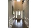 Grand foyer boasts soaring ceilings, hardwood floors, and elegant wainscoting at 160 Elysian Dr, Fayetteville, GA 30214