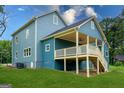 Rear exterior of a two-story home featuring a covered porch with ceiling fan and access stairs at 1993 Reynolds Sw Dr, Atlanta, GA 30315