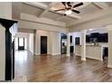 Open-concept living room seamlessly connects to the kitchen with sleek hardwood flooring and modern finishes at 473 Cherry Creek Dr, Loganville, GA 30052