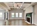 Spacious living room boasts a fireplace, coffered ceiling, and large windows filling the space with natural light at 473 Cherry Creek Dr, Loganville, GA 30052