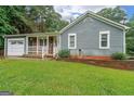 This charming home has a well-kept yard, inviting front porch, and attached one car garage at 295 Pinehurst Dr, Stockbridge, GA 30281