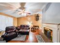 Inviting living room featuring hardwood floors, a classic fireplace, and comfortable leather furniture at 295 Pinehurst Dr, Stockbridge, GA 30281