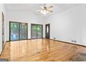 Spacious living room featuring hardwood floors, sliding glass doors, and vaulted ceilings at 655 Sunset Dr, Locust Grove, GA 30248