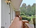 Exterior walkway featuring brick flooring, brick accents, wall lantern lighting and side entrance at 550 Hawthorne Dr, Fayetteville, GA 30214