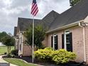 Close up of a brick house with black shutters and manicured landscaping at 10 Wigwam Cir, Whitesburg, GA 30185