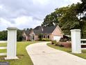 Inviting home with a long driveway, white fence, and a well-manicured lawn at 10 Wigwam Cir, Whitesburg, GA 30185