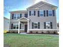 Inviting two-story home with gray siding, black shutters, and a covered front porch entrance at 351 Friendship Oak Way, Hampton, GA 30228