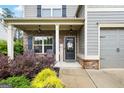 Inviting front porch with brick accents, rocking chairs, and a 'Welcome' sign, enhancing the home's curb appeal at 372 Cobblestone Trl, Dallas, GA 30157