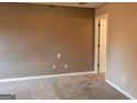 Empty bedroom with neutral walls, carpeted floor, and white trim at 2763 Hunters Ct, Hampton, GA 30228