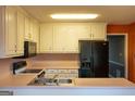 Kitchen features white cabinetry, stainless steel appliances, and light countertops at 2763 Hunters Ct, Hampton, GA 30228