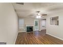 Spacious living room featuring a fireplace, ceiling fan, and wood-look flooring at 8330 N Sterling Lakes Dr, Covington, GA 30014