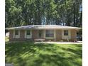 Charming brick home with a well-manicured lawn and mature trees at 10178 Top Tree Ct, Jonesboro, GA 30238