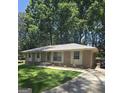 Charming brick home with a well-manicured lawn and mature trees at 10178 Top Tree Ct, Jonesboro, GA 30238