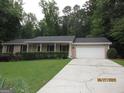 Single-story home featuring a well-maintained yard and attached one car garage at 5848 Navarre Ct, Stone Mountain, GA 30087