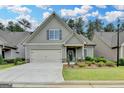 Inviting home with lush landscaping, a two-car garage, and a cozy front entrance at 3112 Patriot Sq, Marietta, GA 30064