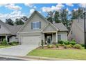 Charming home with a well-manicured lawn and welcoming porch featuring chairs and decorative plants at 3112 Patriot Sq, Marietta, GA 30064