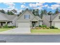 Charming home featuring a well-maintained lawn, a two-car garage, and a welcoming front porch at 3112 Patriot Sq, Marietta, GA 30064
