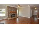 Spacious living room with a stone fireplace, hardwood floors, and abundant natural light at 3112 Patriot Sq, Marietta, GA 30064