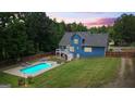 Spacious backyard features a sparkling pool, covered patio, and well-maintained lawn at 150 Surrey Chase Dr, Social Circle, GA 30025