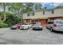 Multi-Gathering home with parking spaces featuring a classic facade with brick accents and mature trees surrounding the property at 3346 Northcrest Rd # A, Atlanta, GA 30340
